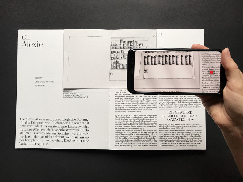 smartphone scanning illustrated parts of an opened book