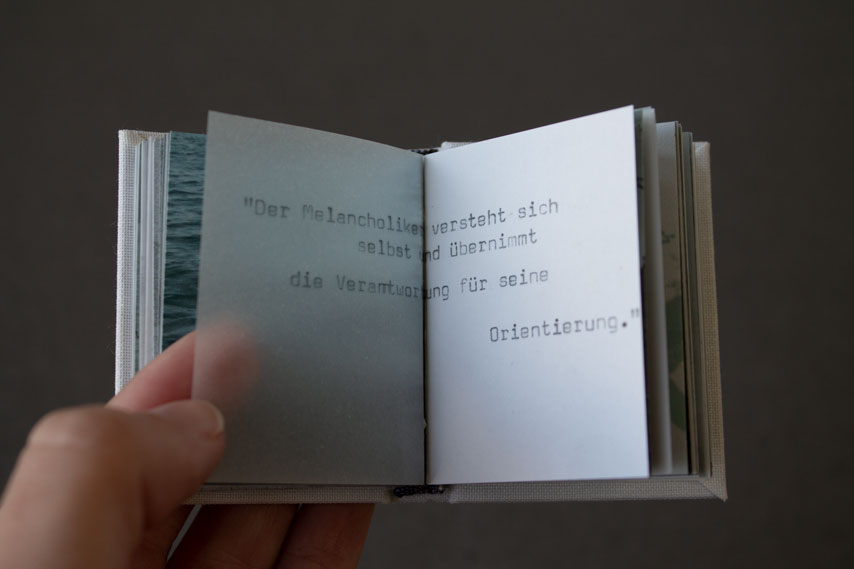 tiny book with typewriter font and transparent paper