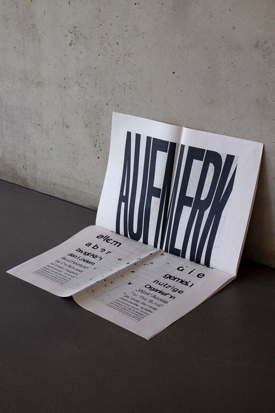 opened typo newspaper upright on the wall