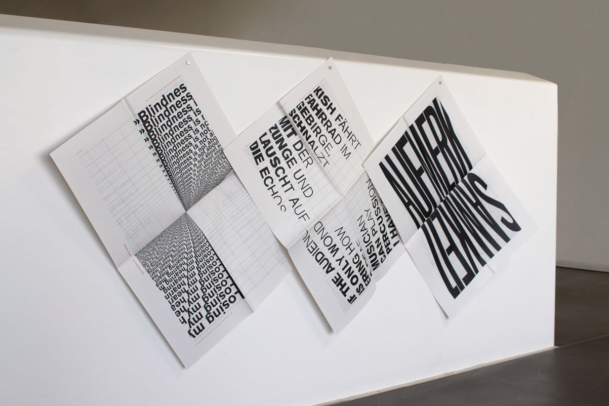 three doublepages of the typonewspaper hanging next to each other