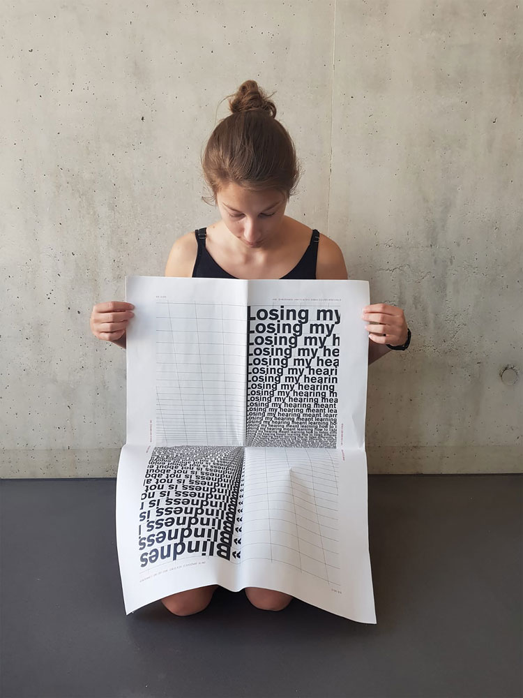 opened typonewspaper showing a double page with letters floating into the middle